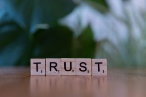 Scrabble tiles spelling the word Trust, symbolizing how to earn trust and respect